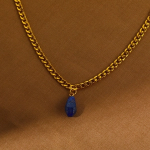 Détail du pendentif goutte en lapis-lazuli sur chaîne en acier plaqué or 18 carats