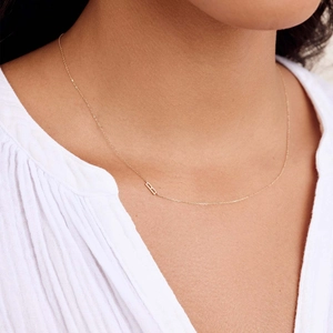 Minimalist 18k gold plated stainless steel letter necklace on a female model