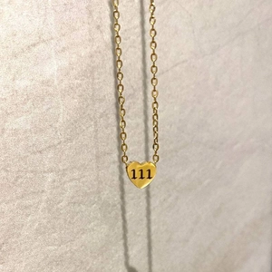 Minimalist gold heart pendant necklace featuring engraved number 111 on a delicate chain