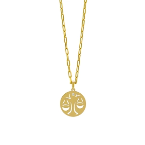 Detailed macro view of gold Libra zodiac pendant with zircon on a paperclip chain