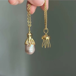 Detail of octopus and jellyfish pendants with baroque pearls and sparkling crystals