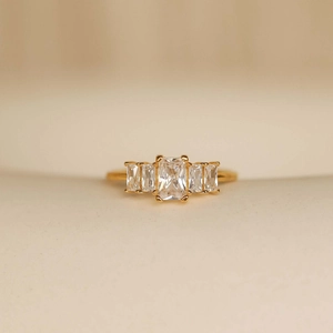 Detailed macro of a gold-plated steel ring with five rectangular zircon birthstones