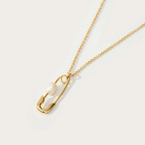 Detailed view of a gold-plated safety pin pendant with a natural freshwater pearl on an O-chain