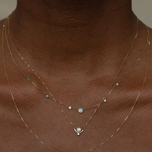 Three-layer gold titanium steel necklace featuring opal stones and emerald drop pendants