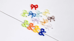 Macro detail of assorted colorful bow beads on wire for DIY jewelry making and crafts
