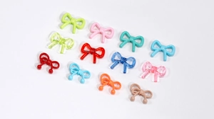Macro shot of colorful bow-shaped acrylic beads for DIY jewelry and accessory making