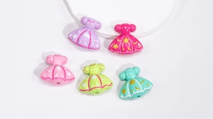 Macro detail of acrylic princess dress beads with star patterns for DIY jewelry crafting
