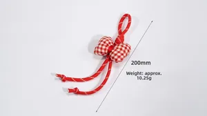 Detail of red and white checkered bow charm with woven strap, 200mm length and 10.25g weight