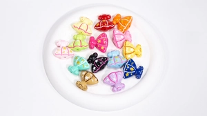 Close-up of colorful acrylic dress-shaped beads with star and moon patterns for DIY crafts