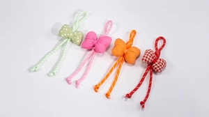 Detailed view of four colorful handmade fabric bow phone straps with checkered patterns