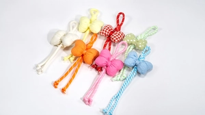 Detail of seven colorful handmade fabric bow charms with diverse patterns for phone or bags