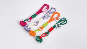 Detail of colorful braided rope keychains with decorative knots and fashion tags