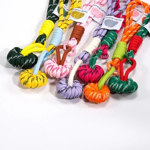 Colorful handmade braided pumpkin phone charms and keychains in various vibrant color schemes