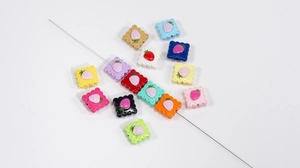 Detail view of colorful acrylic strawberry biscuit beads for DIY jewelry making and crafts