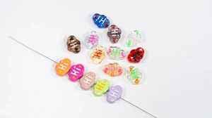 Macro detail of colorful cloud-shaped DIY beads with Hi lettering for jewelry making