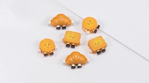 Detailed view of 6 cute acrylic croissant and cookie beads for DIY jewelry making