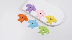 Detailed close-up of six colorful enamel poodle charms for keychains and accessories