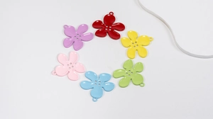 Detail view of 6 colorful alloy flower charms with polished enamel finish and 4-hole design