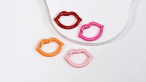 Detailed view of colorful lip-shaped metal spring buckles for DIY bag accessories