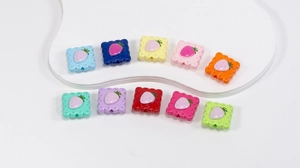 Macro shot of colorful strawberry soda cracker acrylic beads for DIY jewelry making and crafts