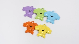 Flat lay showing five colorful cartoon dog charms in purple green blue orange and yellow