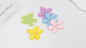 Macro shot of colorful five-petal flower alloy charms with four-hole design and top ring