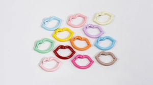 Detailed flat lay of colorful lip-shaped alloy spring gate rings in twelve vibrant shades