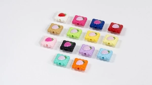 Macro shot of assorted acrylic strawberry biscuit charms for DIY jewelry and crafts