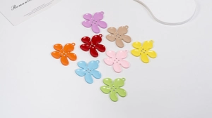 Macro detail of colorful four-eye flower charms for DIY keychains and accessories