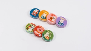 Detailed view of flat round colorful DIY beads with cute dog prints for jewelry making