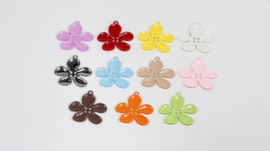 Close-up of four-hole flower charms in eleven vibrant colors for jewelry making