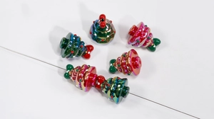 Macro view of iridescent Christmas tree resin beads with metallic rainbow finish