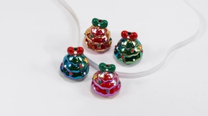 Macro shot of colorful metallic Christmas tree charms with bows for DIY jewelry