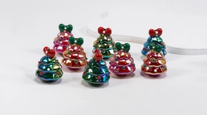 Macro detail of glossy Christmas tree resin pendants with colorful bows for DIY crafts