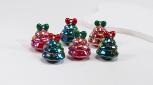 Close-up of colorful resin Christmas tree beads with bows for DIY jewelry making