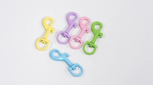 Macro detail of macaron-colored swivel lobster clasps with matte painted finish