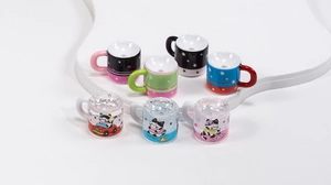 Macro shot of seven transparent acrylic beads featuring cartoon cat and star patterns