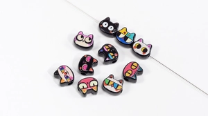 Macro shot of cartoon cat head acrylic beads with colorful expressions for DIY jewelry making