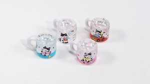 Macro view of four transparent acrylic mini cartoon cat cups for DIY jewelry making