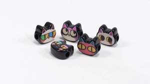 Detailed macro view of 5 cartoon cat acrylic beads with various cute facial expressions