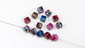 Detailed view of colorful 3x3 grid acrylic cube beads on a wire for DIY jewelry making