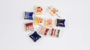 Macro view of assorted acrylic cartoon bear beads with polished finish for DIY jewelry