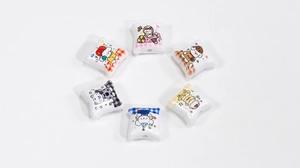 Close-up of six DIY acrylic white beads with various cute cartoon puppy dog prints