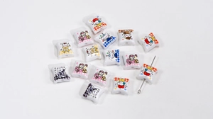 Close-up of DIY acrylic beads with cute printed cartoon cats and dogs for keychains