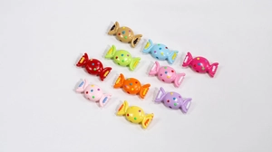 Close-up of assorted colorful acrylic candy-shaped beads with polka dot patterns for DIY crafts