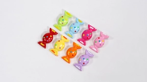 Macro detail of colorful candy-shaped acrylic beads with polka dots for DIY jewelry making