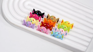 Close-up of colorful candy-shaped acrylic beads with polka dots for DIY jewelry making