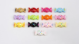 Detailed view of colorful acrylic candy-shaped beads with polka dots for DIY jewelry