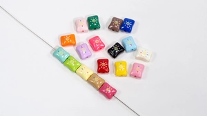 Macro view of colorful acrylic candy beads with sun swirl pattern for DIY jewelry making