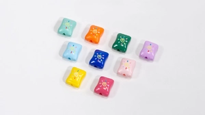 Macro shot of colorful acrylic candy beads with G pattern for DIY jewelry making